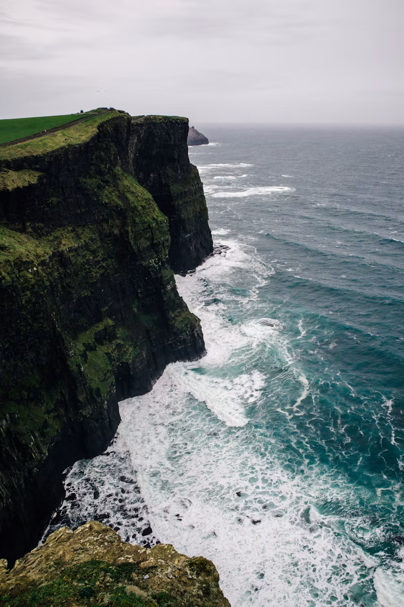 Distant walker looking across the sea from Bempton Cliffs