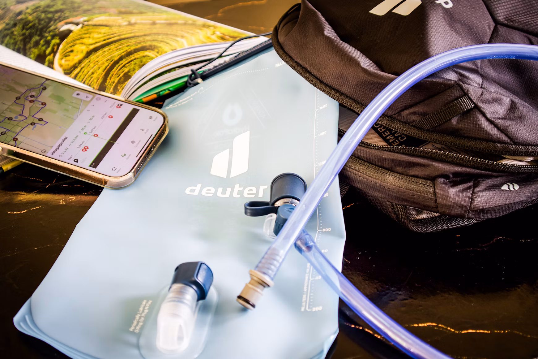 Hiking backpack, water bladder and offline route map on a phone