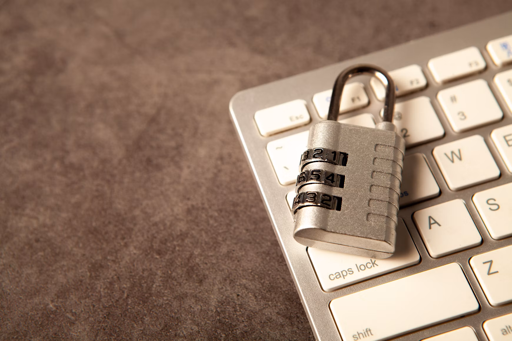 Closed padlock resting on a computer keyboard