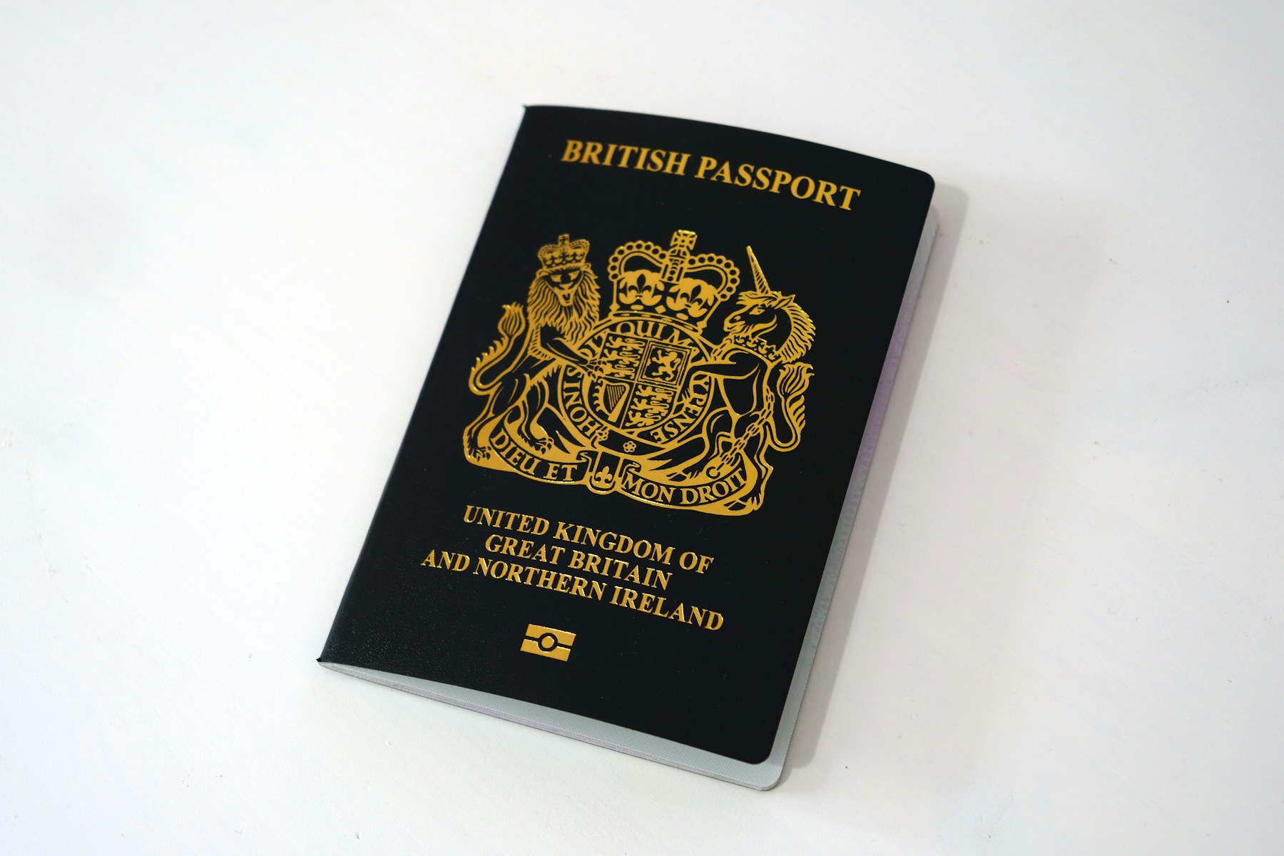 Dark blue British passport on a light table