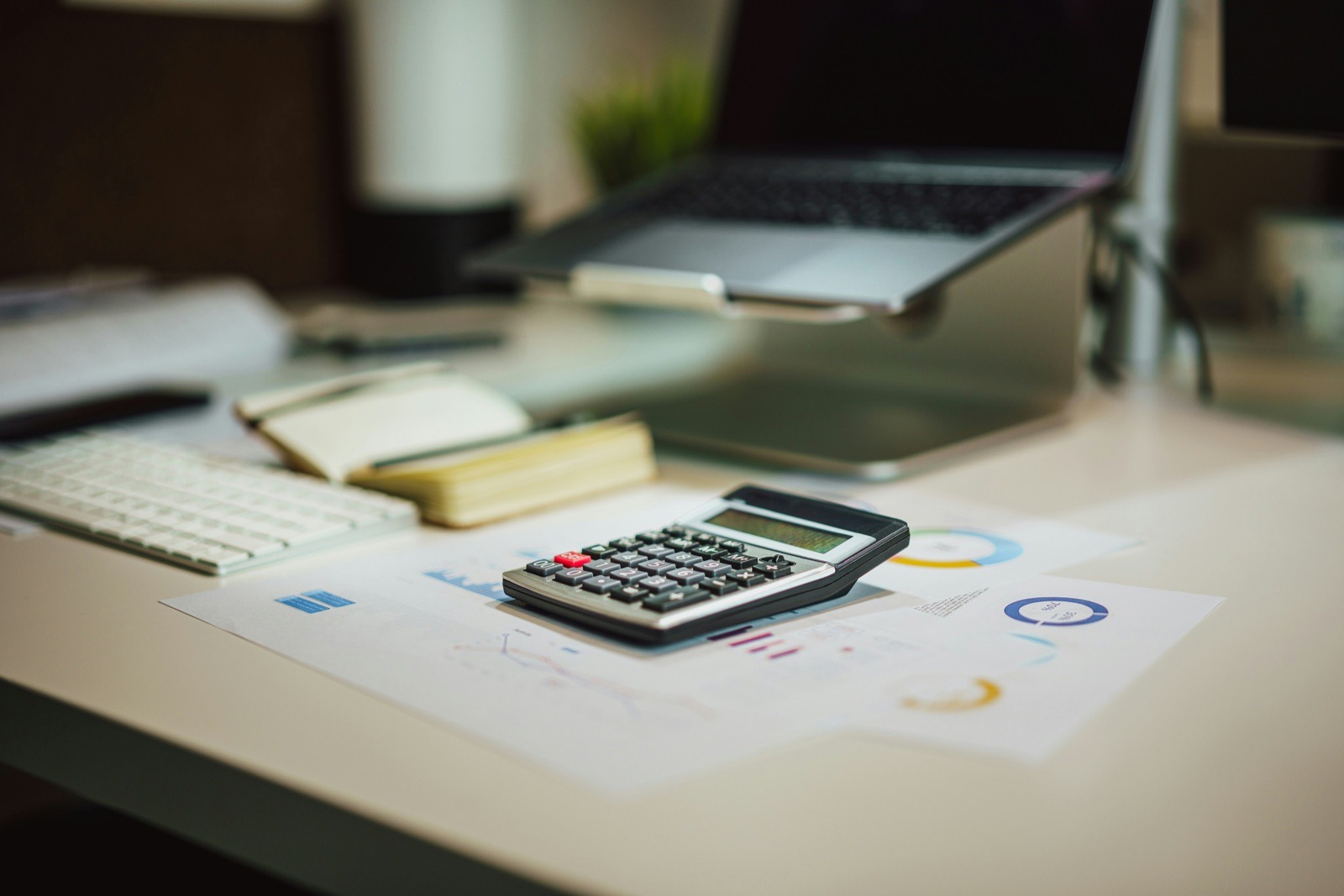 Calculator and laptop used for financial work.