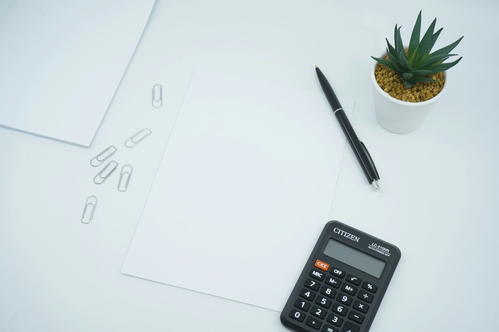 Blank working paper, calculator and pen.