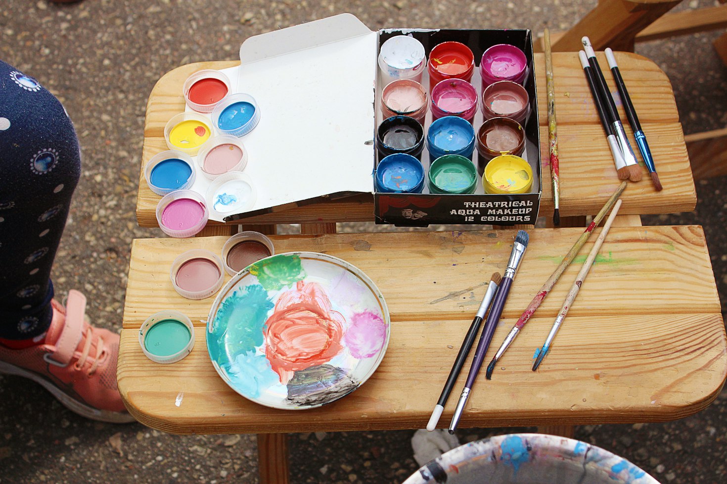Paints and brushes arranged on an activity table