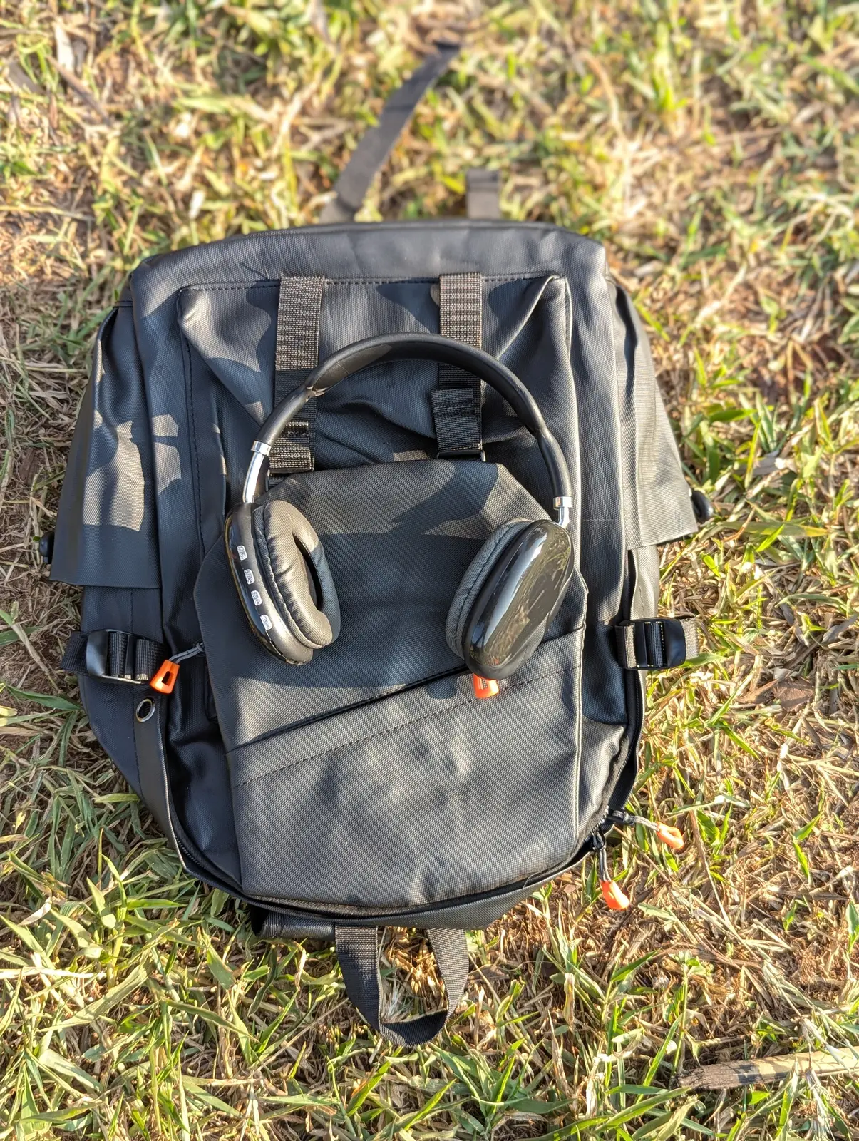 Black travel backpack on grass