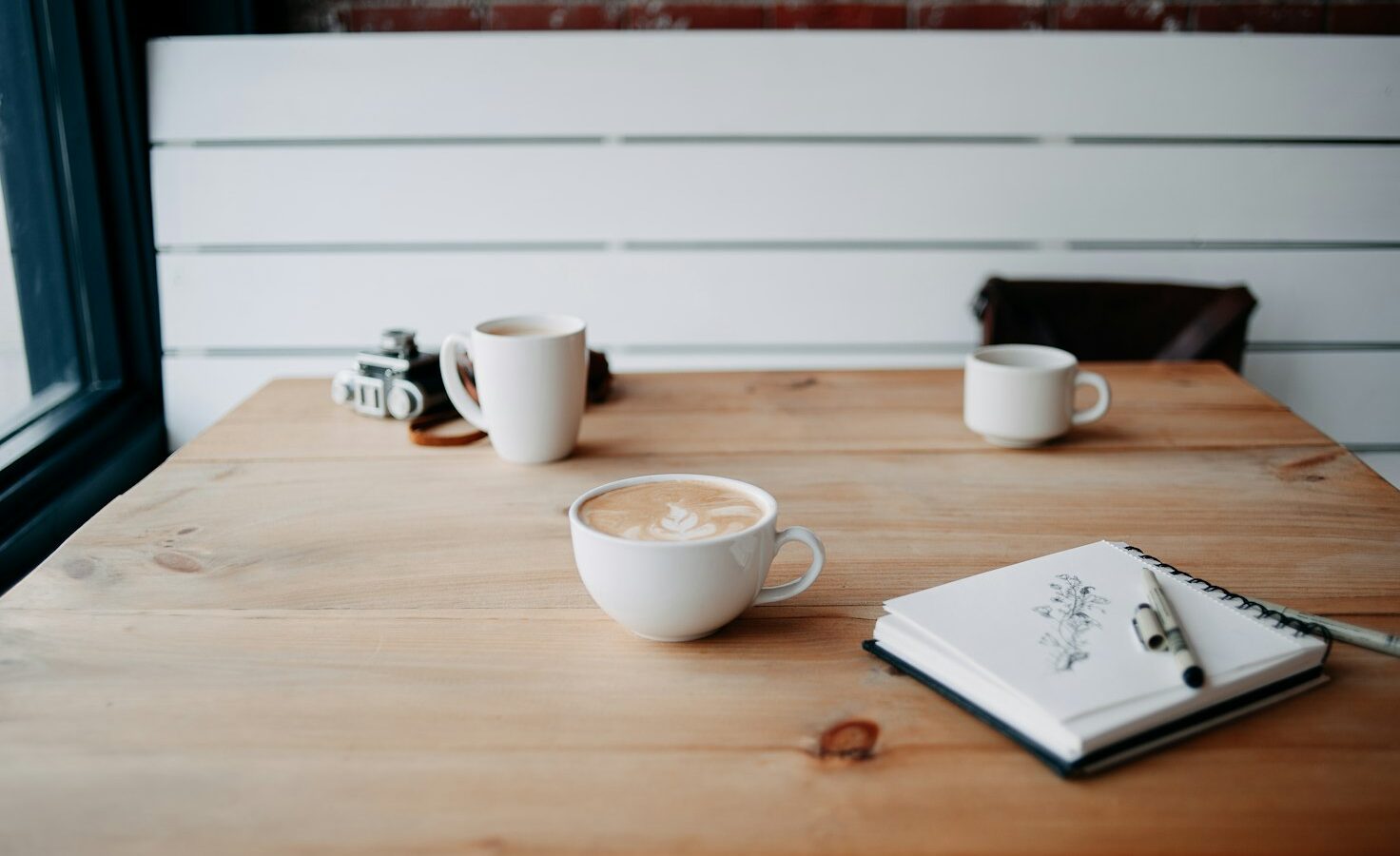 Two cups of coffee on a wooden table