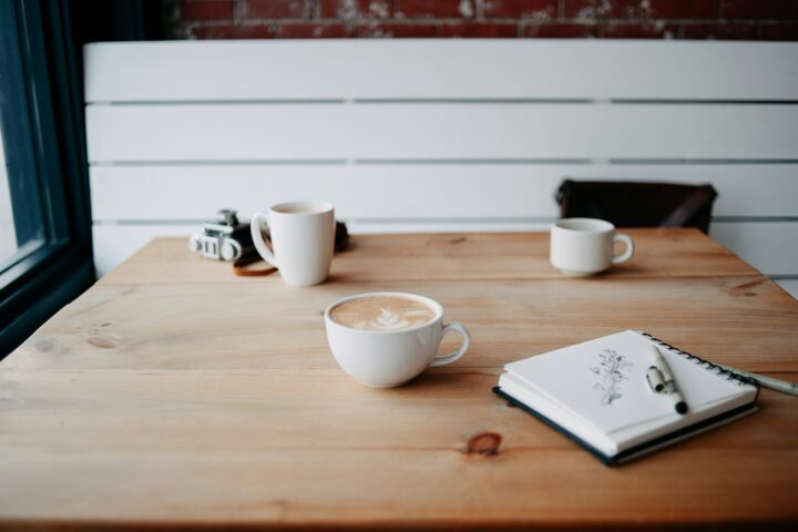 Two cups of coffee on a wooden table