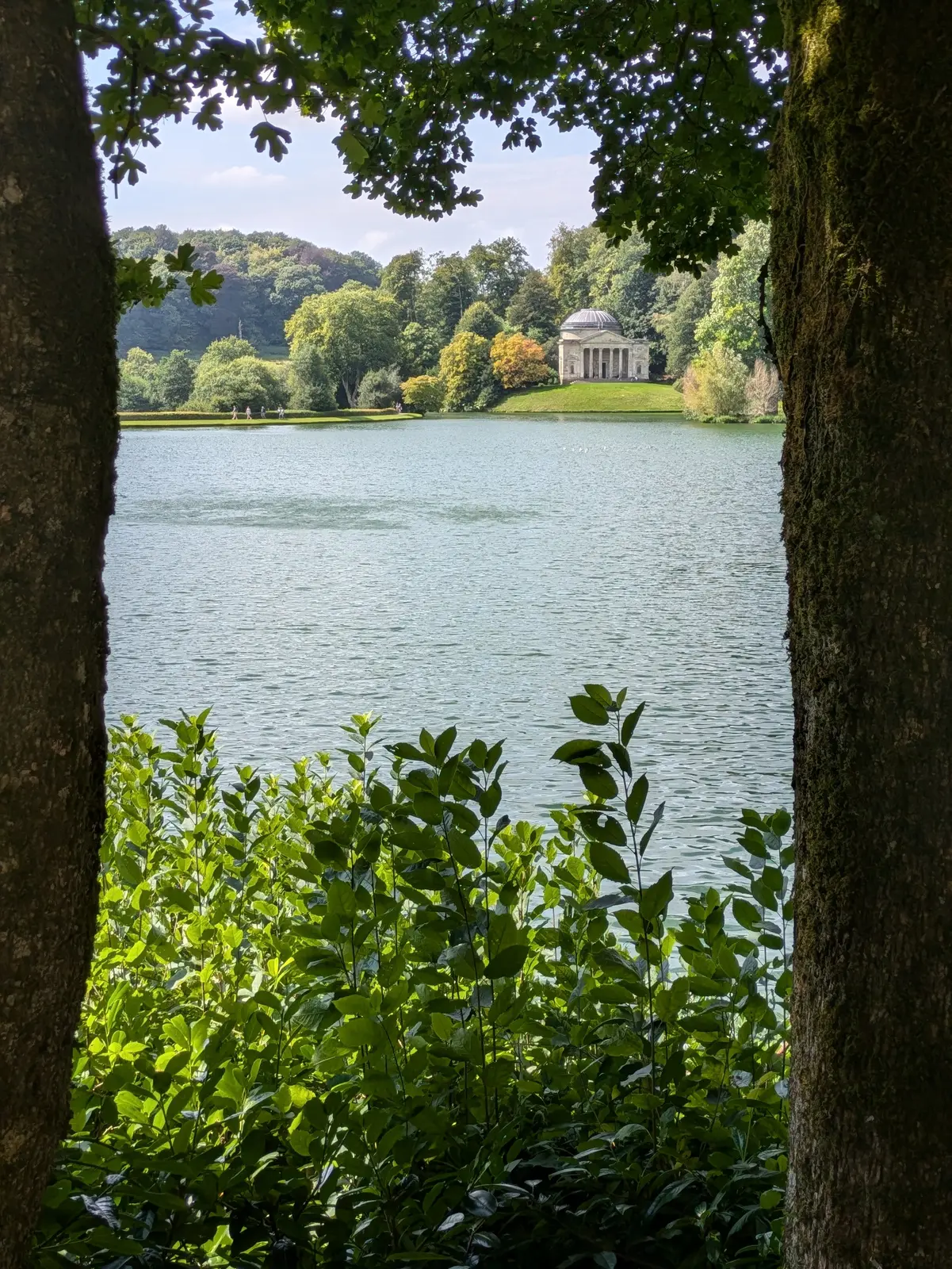 Stourhead lake and temple framed by trees