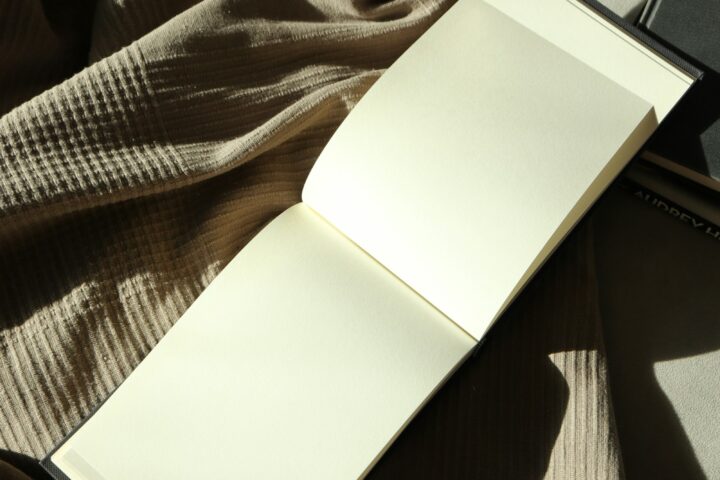 Open notebook resting on a bed in soft light