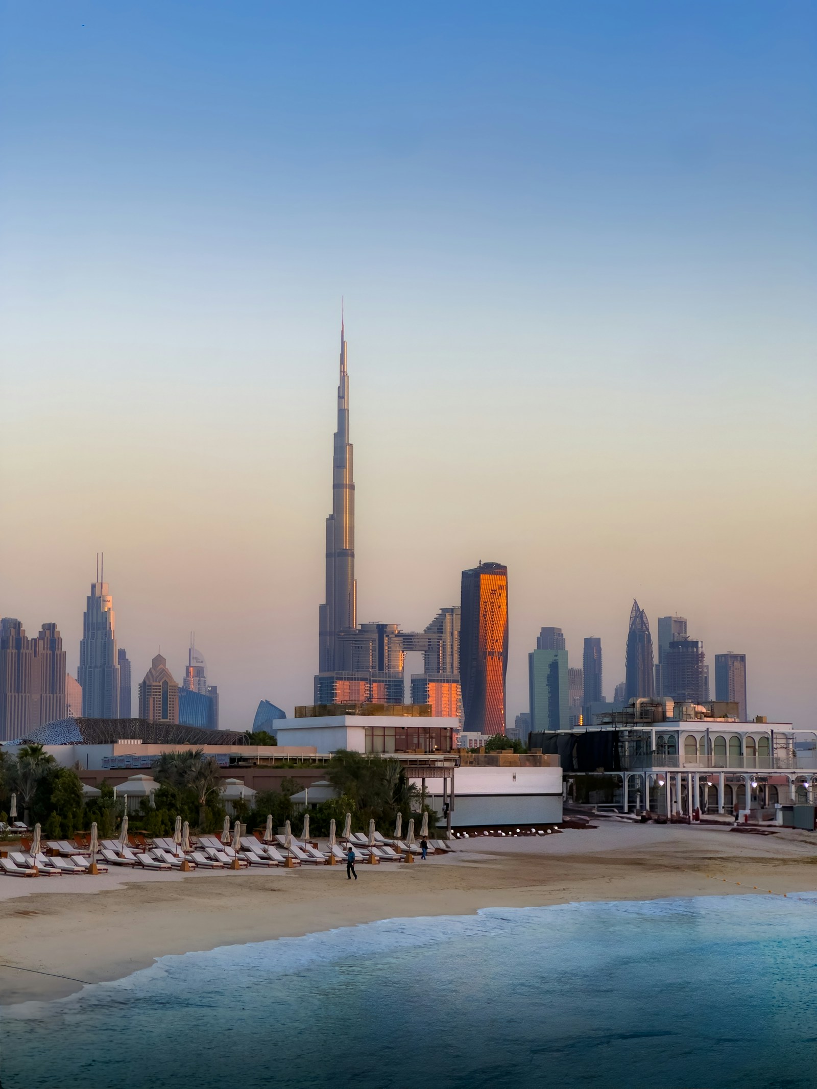 Dubai skyline rising behind a beach