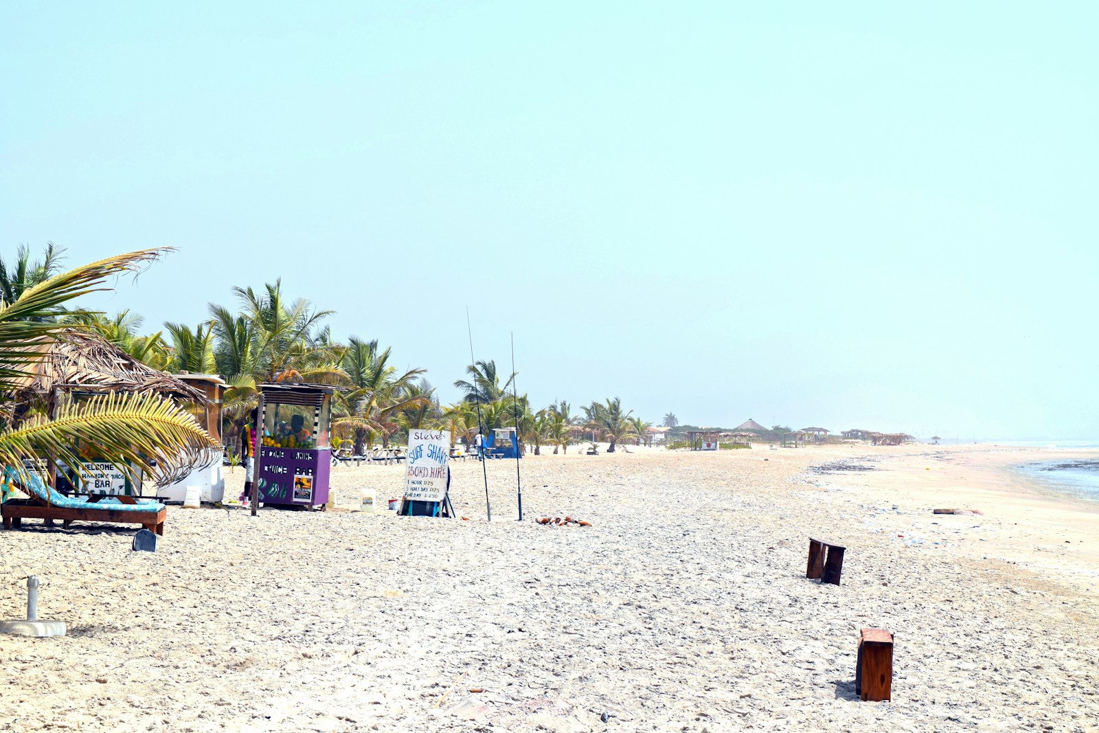 Sandy beach with chairs and umbrellas at Sanyang in The Gambia